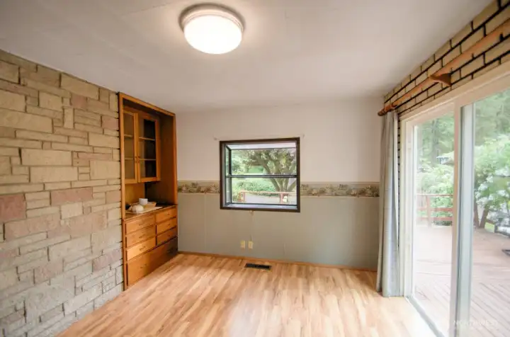 The back of the fireplace creates a custom accent wall to the dining room, which also harbors a built-in hutch.