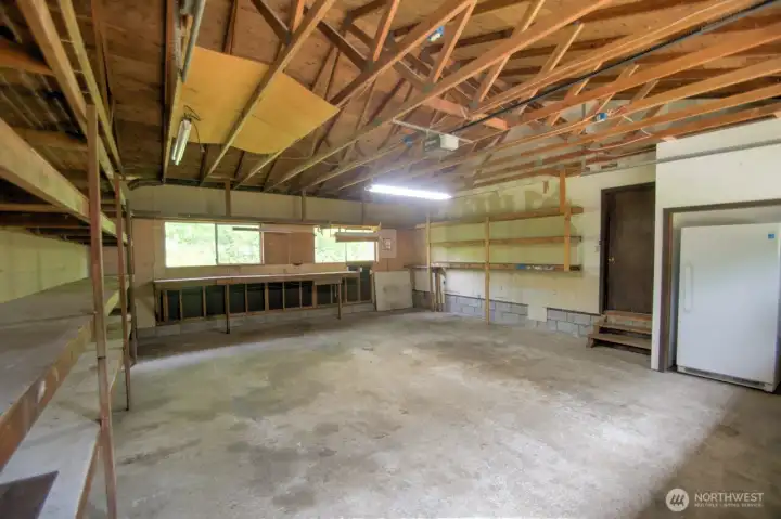 Double garage is deep an ringed with storage shelving. There are also washer and dryer hook ups.