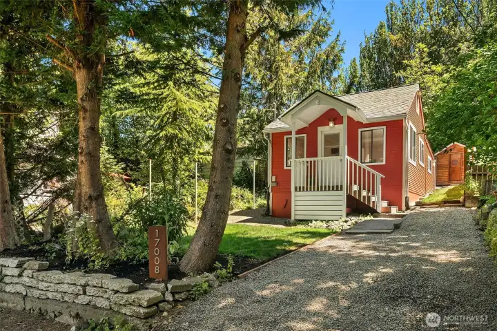 Darling vintage cottage sits up above the quiet lane.