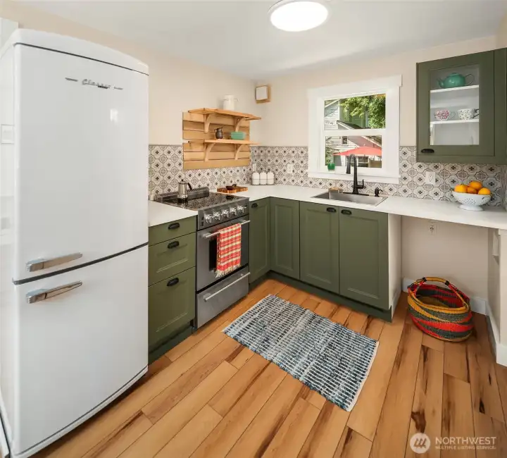 All new cabinetry, range, refrigerator, sink and counters. Plumbed  on the right for a dishwasher or combo washer/dryer.
