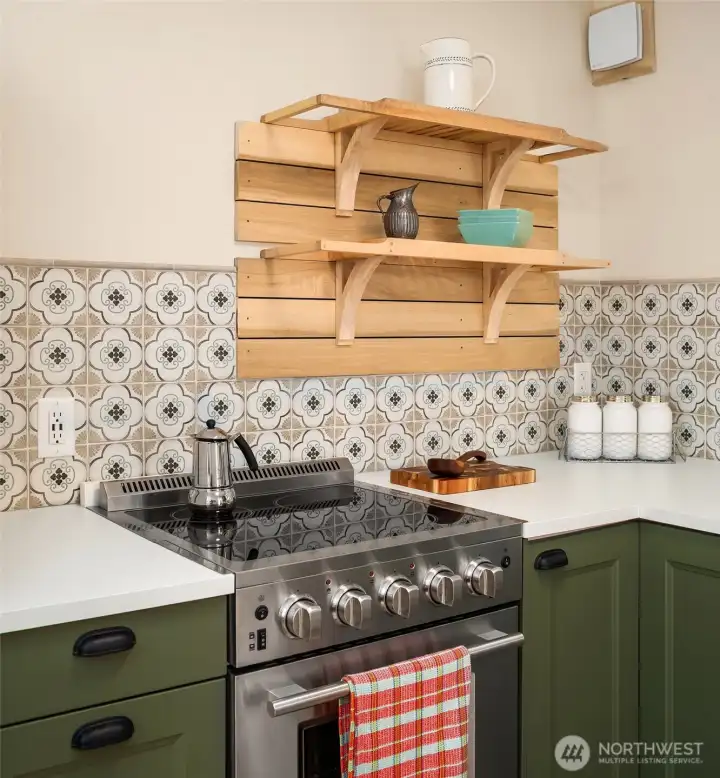 Custom tile backsplash with open shelving. Designer touches throughout!
