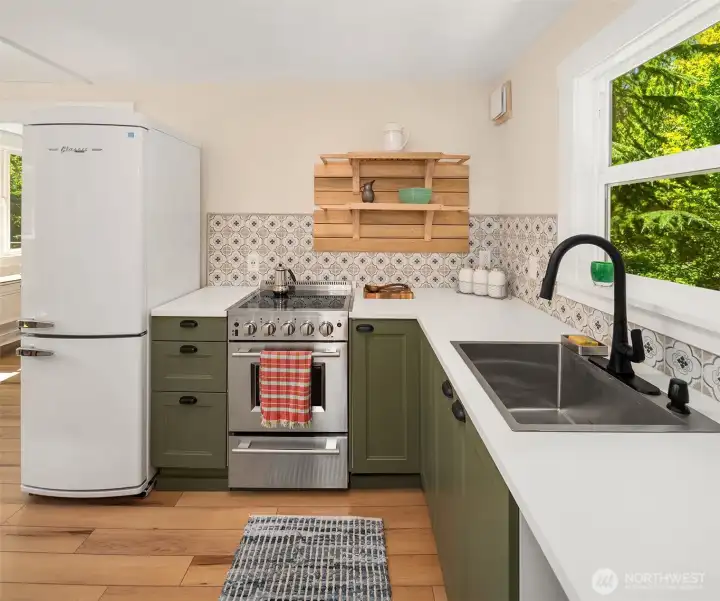 Appliances were thoughtfully chosen to fit the vibe and size of the house. Great big, deep stainless sink makes clean up a breeze.