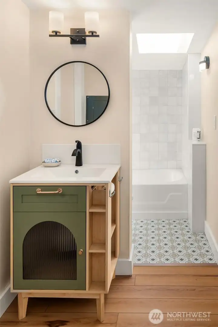 The modern touches meld perfectly with the character of the home. Custom tiled floor and tub surround. All new fixtures.
