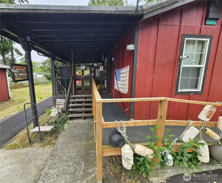 Ramp leading to the front door with the stairs to the left.
