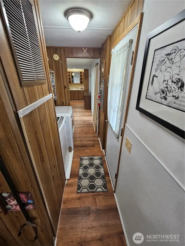Hallway to the primary bedroom, washer and dryer included.
