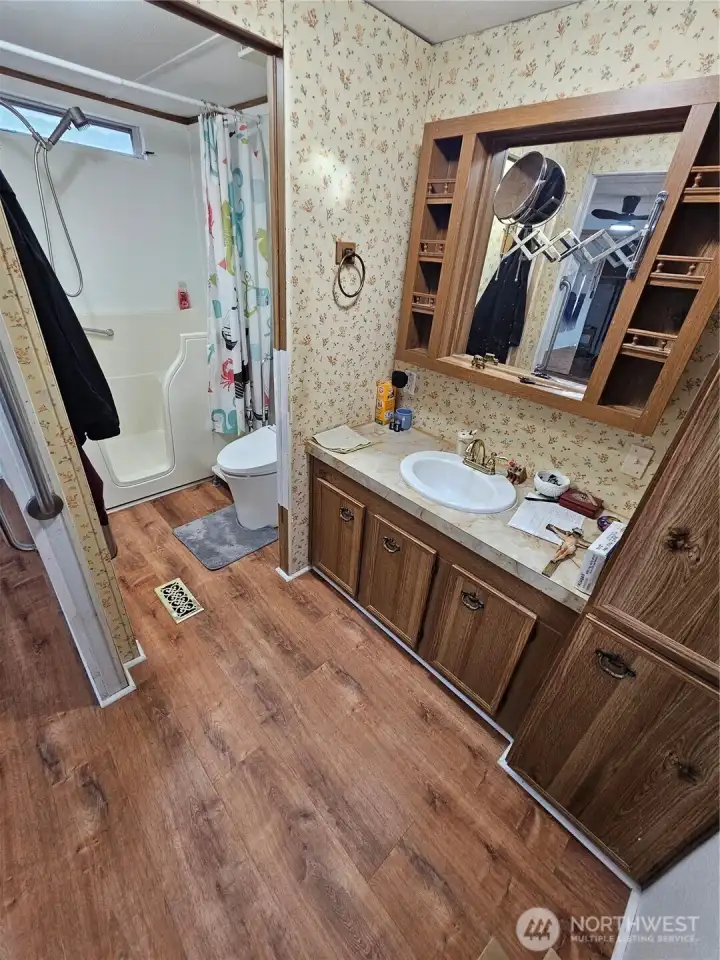 En-suite bathroom in the primary bedroom with a walk-in tub and shower combo.
