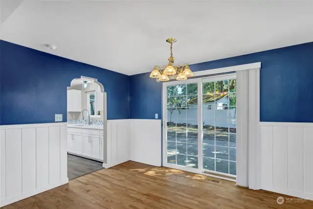 Looking thru the dining area into fully remodeled kitchen and French doors to the right out into back patio and fully fenced back yard