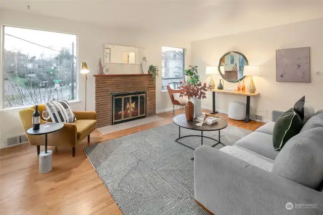 Living room of Unit 2218, wood burning fireplace and oak hardwoods throughout. It’s now vacant and staged.