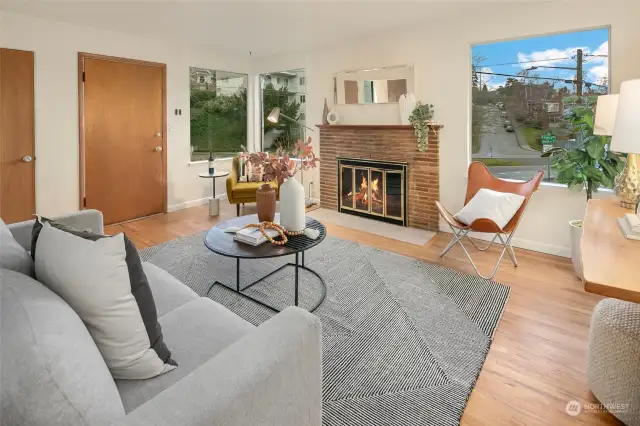 Living room of Unit 2218, wood burning fireplace and oak hardwoods throughout. It’s now vacant and staged.