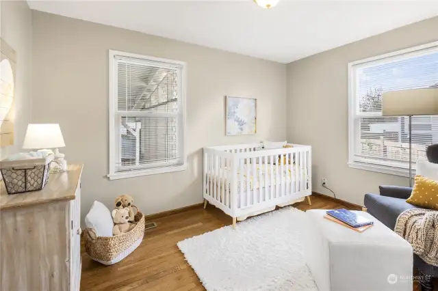 Second of two bedrooms on the main floor with hardwood floors and double pane vinyl windows.