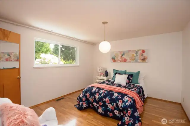 3rd bedroom with walk in closet overlooking the backyard.  Queen size bed