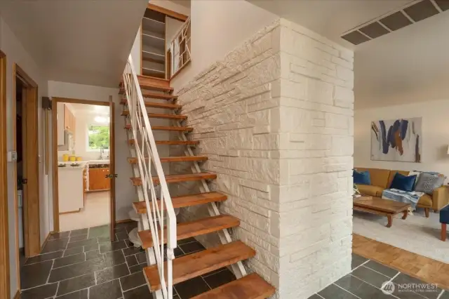 As you enter take in the Midcentury architecture. To the left is an office or 5th bedroom. Living and formal dinning to the right. Full bath and kitchen straight ahead.