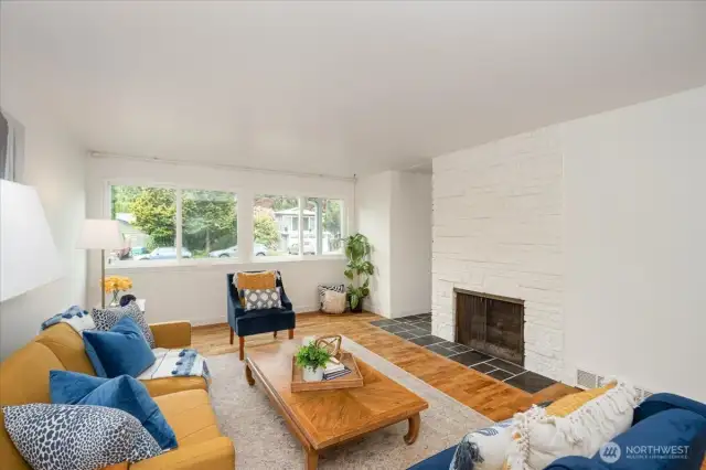 Wood burning fireplace for cozy nights. Bank of double pane windows allows the room to fill with light.