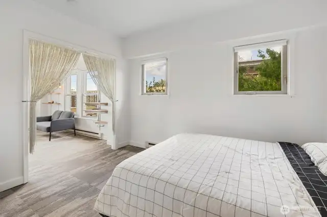 Bright windows in the bedroom let in the morning light