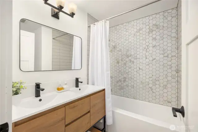 Guest bathroom.   Recently upated with new bath, vanity, lights,and more. Custom tile backsplash.
