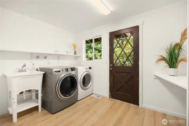 Main level laundry has a utility sink and a 1/2 bath. And easy access to the back yard!