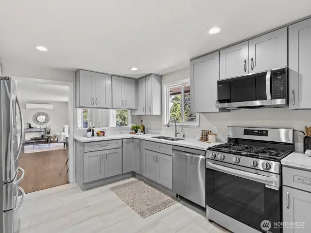 New luxury vinyl tile compliments the wood floors and pairs wonderfully with the new gray cabinets.