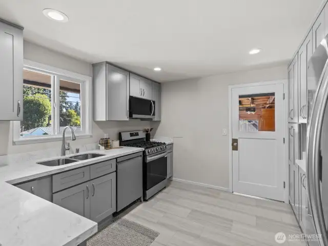 Soft close doors and drawers, gleaming new appliances and stunning countertops complete these top notch kitchen. It's not often you find a kitchen like this in a home of this size.