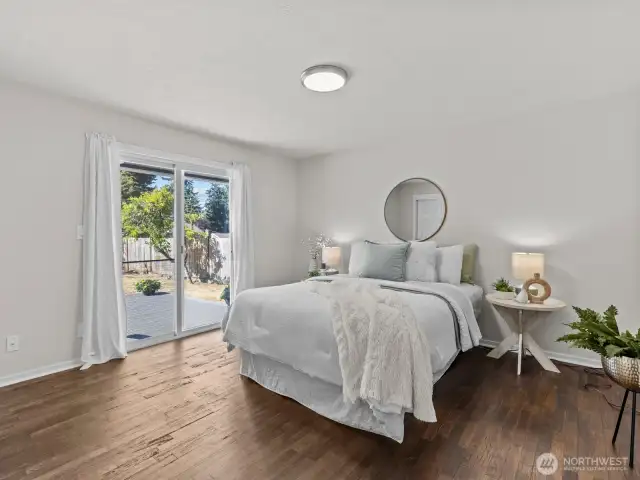 The primary bedroom provides access to the back deck.