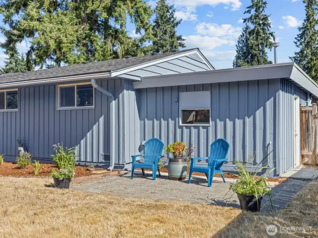 The paver patio on the other side of the garden could be used for an outdoor table and grilling spot.