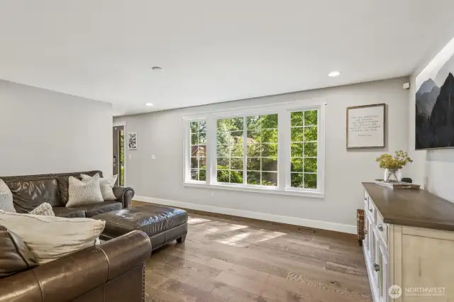 Sunlight pours in through abundant windows to accent sparkling engineered hardwood floors that flow throughout the main level.