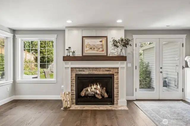 A newer gas fireplace with a brick surround and fan to push out heat keeps you cozy on rainy winter evenings.