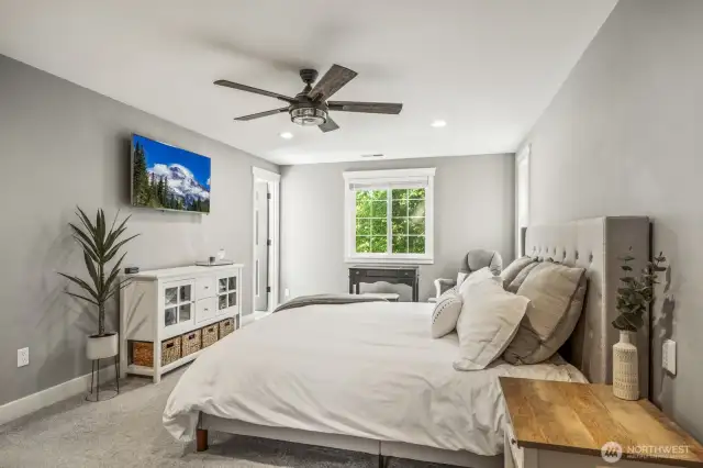 Head upstairs to see all four bedrooms, including this bright and airy primary suite.