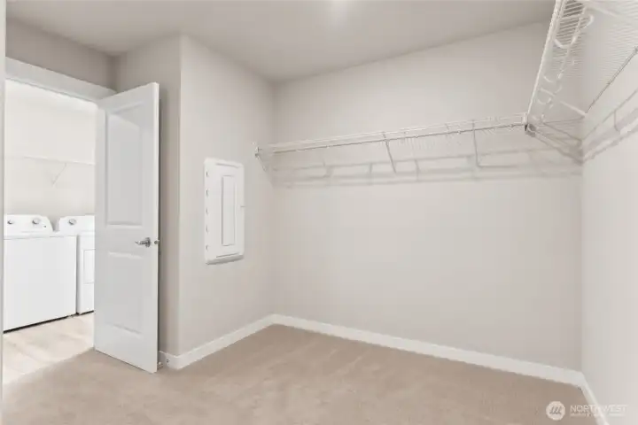 Laundry room is located just outside the primary closet with separate door and access to the closet for ease of hanging clothes. Photos are for example only. Model home of the same plan and may reflect different colors and options.