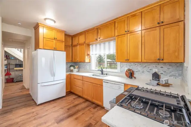 Extra tall ceilings = more cabinet space! New quartz counters & full tile backsplash add a beautiful touch