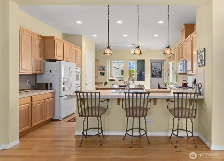 This is the sweet view from the great room into the kitchen.  In the Monticello floorplan, the kitchen is the heart of the home both figuratively and literally.  Notice the convenient breakfast bar that is at the perfect height for everyday use. Just love this!