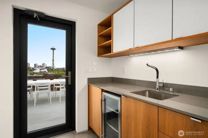 Anticipation, drawing you upward to the crown jewel of the home: a rooftop sanctuary with sweeping city views.