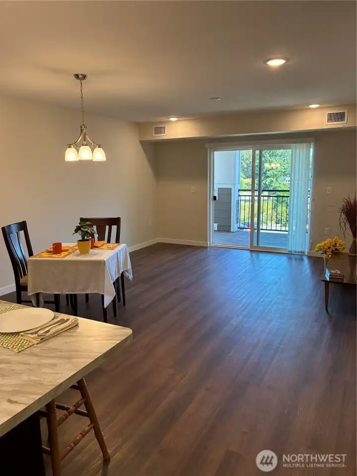 Great room style living, dining and kitchen with access to private balcony.