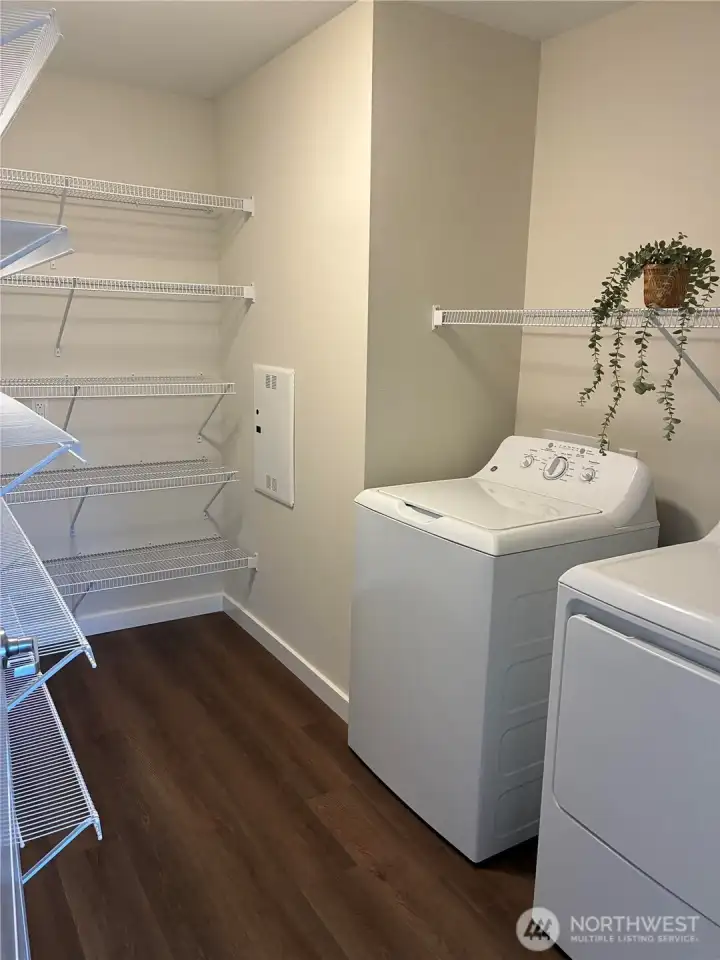 In home washer/dryer with great storage shelving.