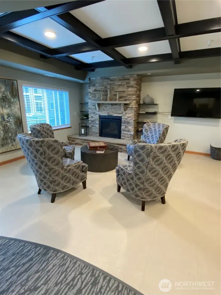 Natural gas fireplace seating area near entrance.