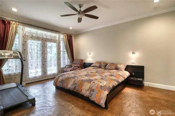 Primary bedroom with French doors and ceiling fan.