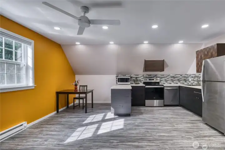 Bonus room above the garage with ceiling fan.