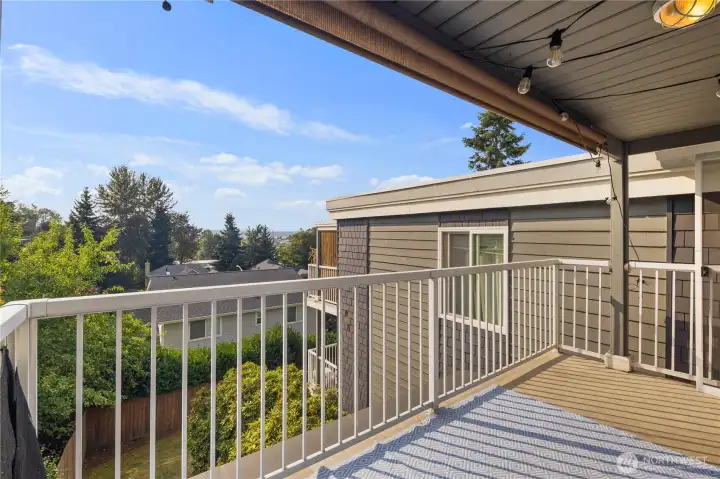 Balcony: Covered balcony offers year-round outdoor living space with treetop privacy and peek-a-boo views of Lake Washington and the Olympic Mountains. Perfect for relaxing, entertaining, or enjoying sunsets.