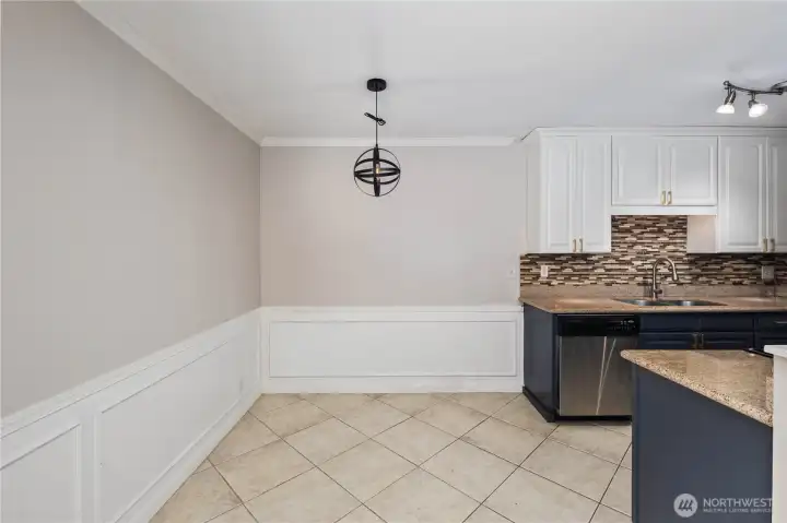 Dining Area: Cozy dining space with tile flooring and modern pendant lighting. Positioned between the kitchen and living room, it offers an ideal spot for everyday meals or entertaining.