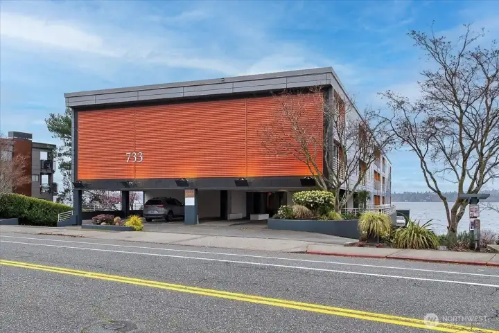 The architecturally distinctive 733 Lake Street S makes an immediate impression with its bold copper-toned corrugated exterior and clean modern lines, sitting directly on the shores of Lake Washington. Ideally positioned within the building for privacy and tranquility, with covered parking and just steps from Kirkland's vibrant waterfront dining, boutique shopping, parks, and the beloved David E. Brink Park pier — this is downtown Kirkland waterfront living at its finest.