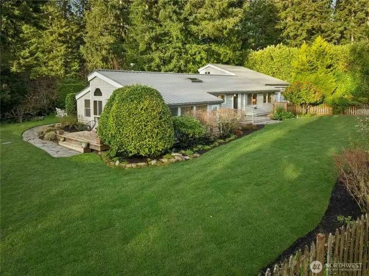 Surrounded by a picket fence and flat grassy spaces, this three bedroom, two bath 1828 sf home sits on a .40 acre lot.