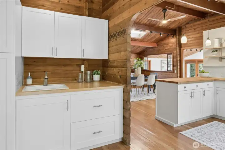 Generous bonus storage in the alcove next to the kitchen that has a pantry, drawers and another sink.