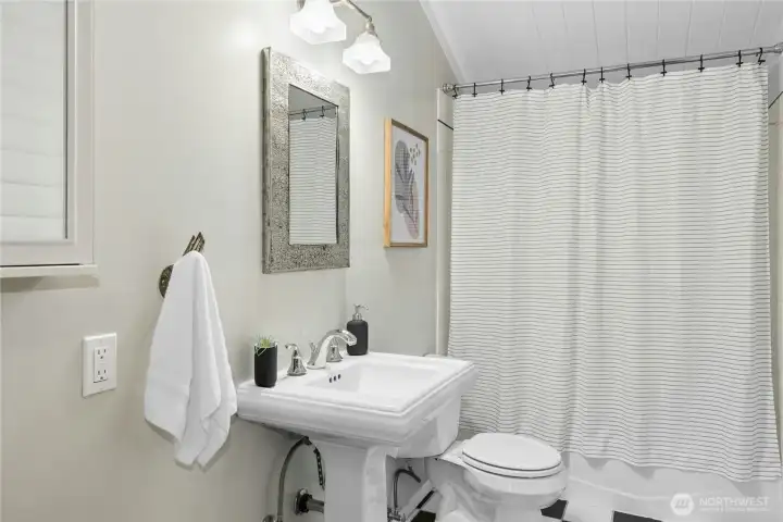 The main hallway bathroom with a tub/shower combo and updated fixtures.