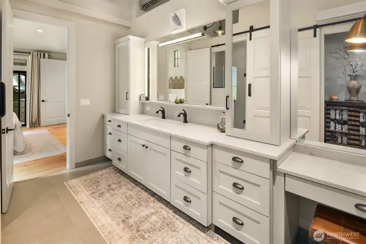 Tons of counterspace and lighting in this high beamed primary bath.