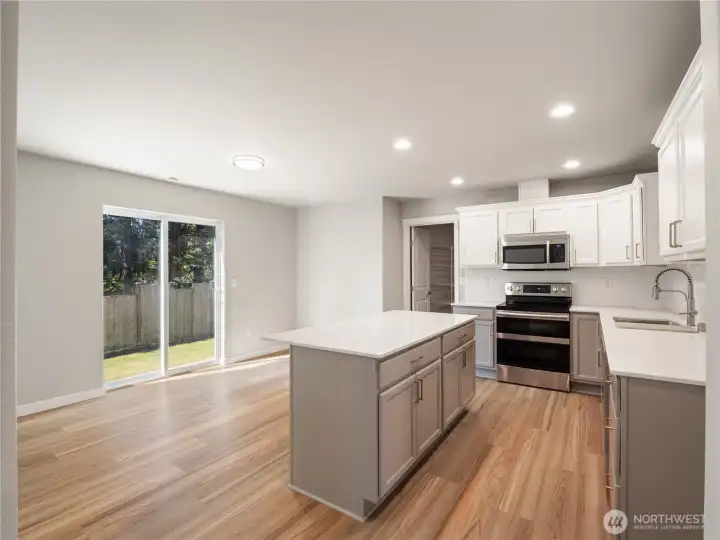 Enjoy the newly installed spacious kitchen island designed for bar seating, complemented by a nearby dining area ideal for a traditional table setup.