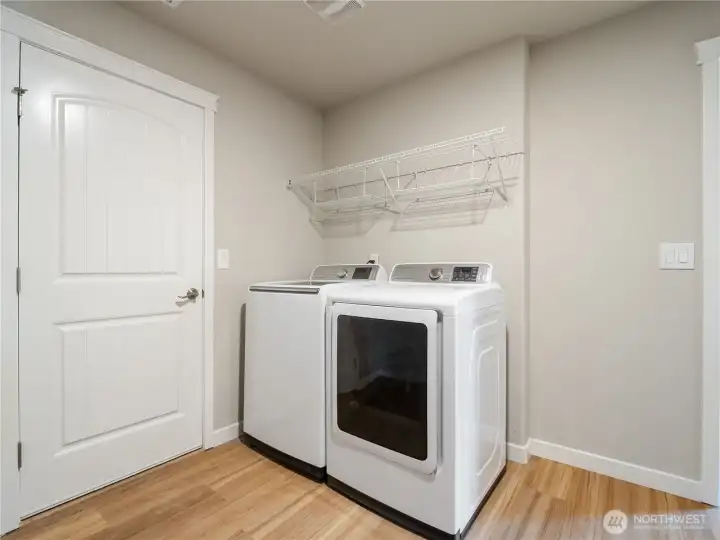 A convenient utility room connects the pantry to garage access, creating a highly functional and efficient space.