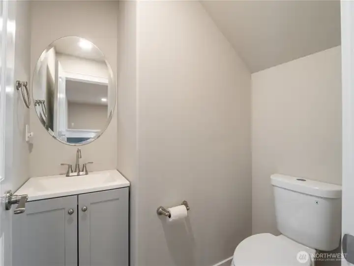 The main level half bath offers added convenience for guests without the need to go upstairs.