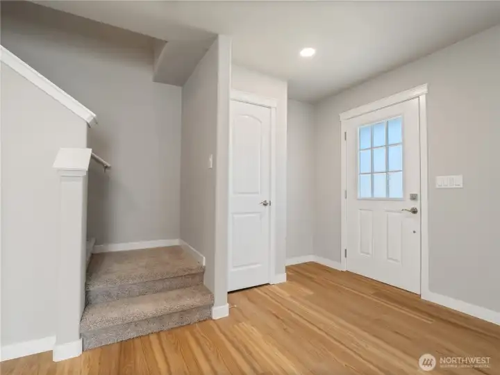 Just off the entryway, stairs to the upstairs are paired with a nearby coat closet for added functionality and organization.