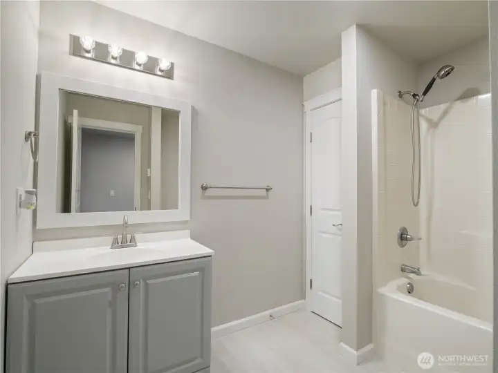 The full-size bathroom also includes a built-in closet, adding storage right within the space.
