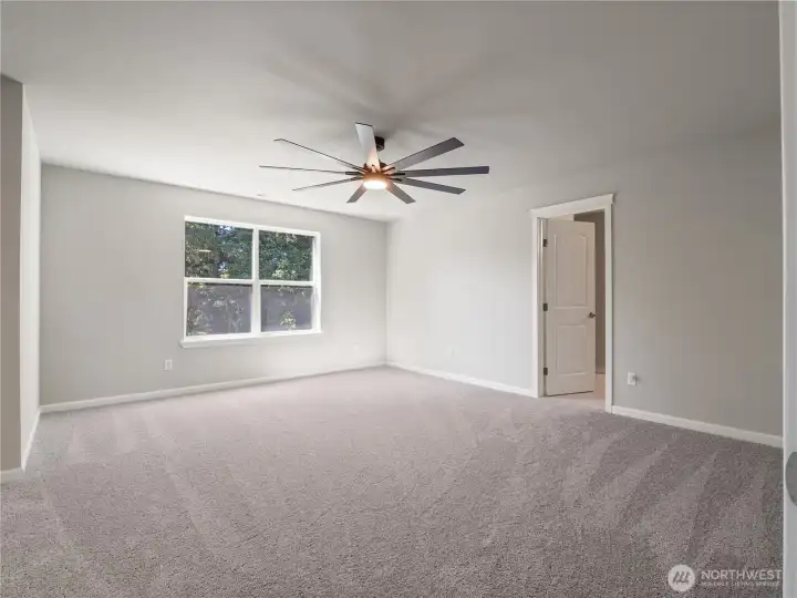 Connected to the primary suite is a spacious primary bathroom and a large walk-in closet for the ultimate convenience.