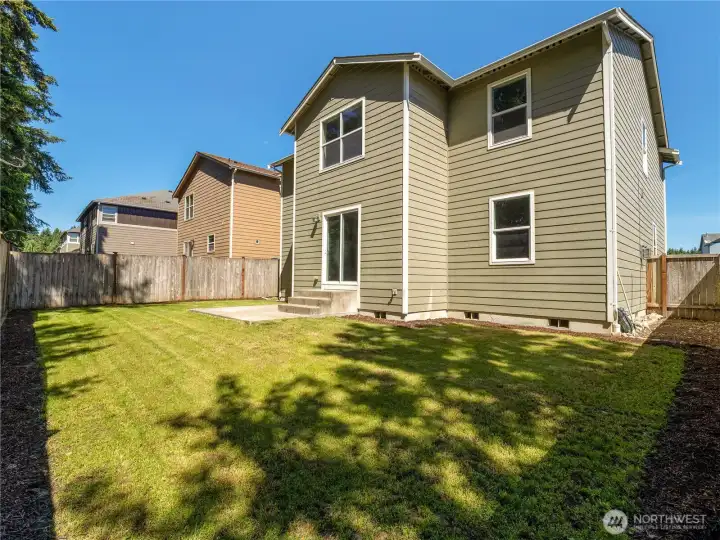 The fully fenced backyard offers a private outdoor retreat with a patio and convenient side gate access.